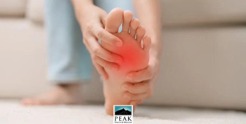 Diabetic Neuropathy Pain in foot. Woman holding sore area.